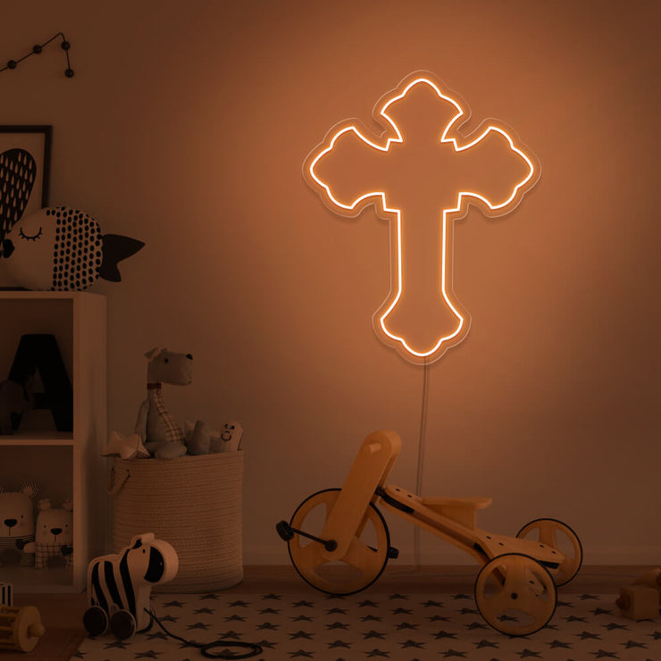 orange cross neon sign hanging on kids bedroom wall