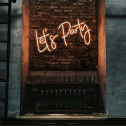 orange lets party neon sign hanging on bar wall