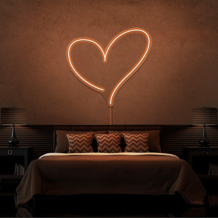 orange love heart neon sign hanging on bedroom wall