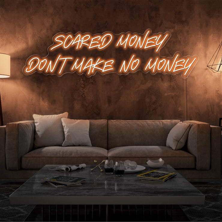 orange scared money dont make no money neon sign hanging on living room wall