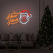 orange new year santa neon sign hanging on living room wall