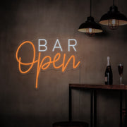orange open bar neon sign hanging on bar wall