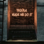 orange tequila made me do it neon sign hanging on bar wall