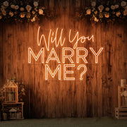 orange will you marry me neon sign hanging on timber wall