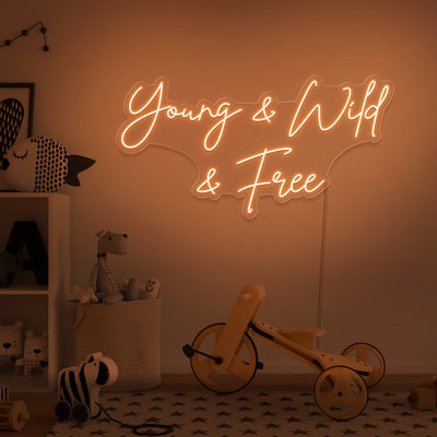 orange young wild and free neon sign hanging on kids bedroom wall