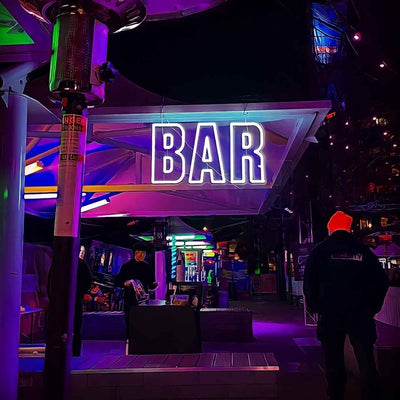 cold white outdoor bar neon sign at event
