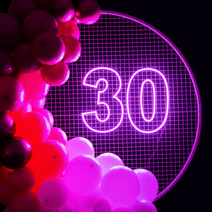 hot pink 30 neon sign on backdrop frame with balloons
