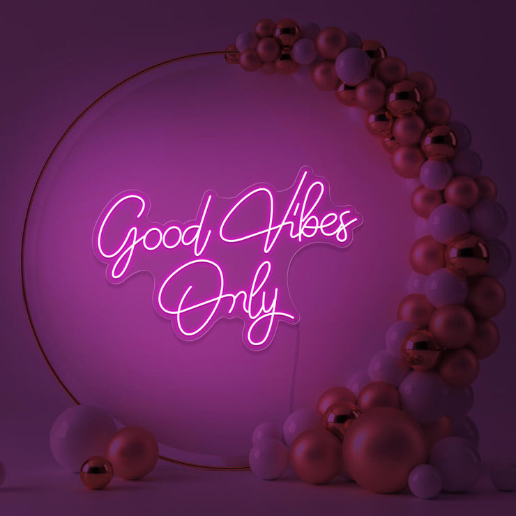 hot pink good vibes only neon sign hanging inside balloon hoop backdrop