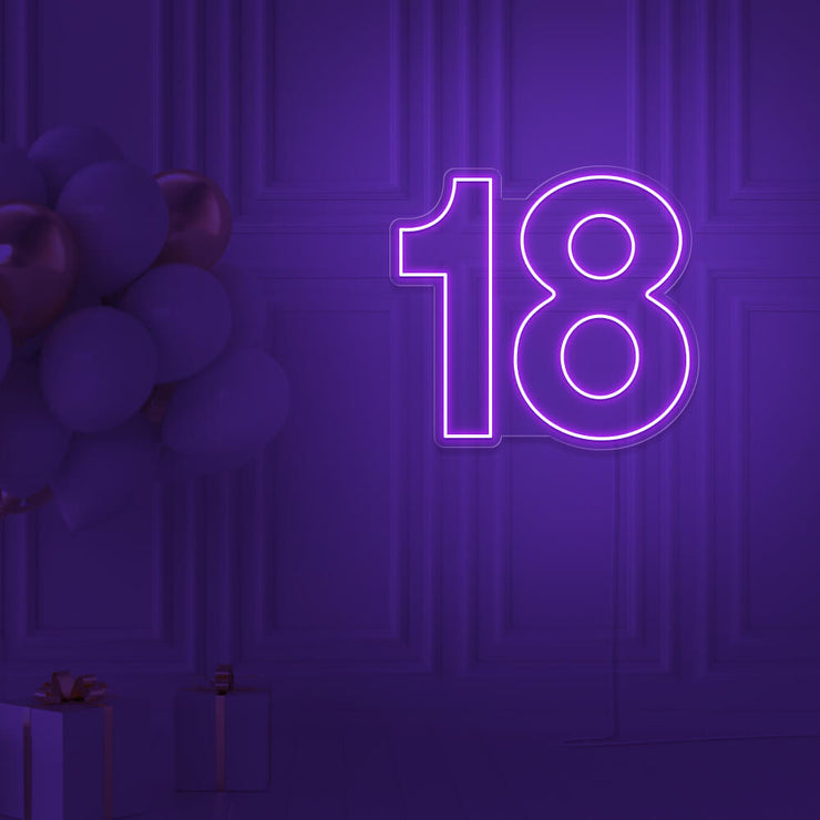 purple 18 neon sign hanging on wall with balloons