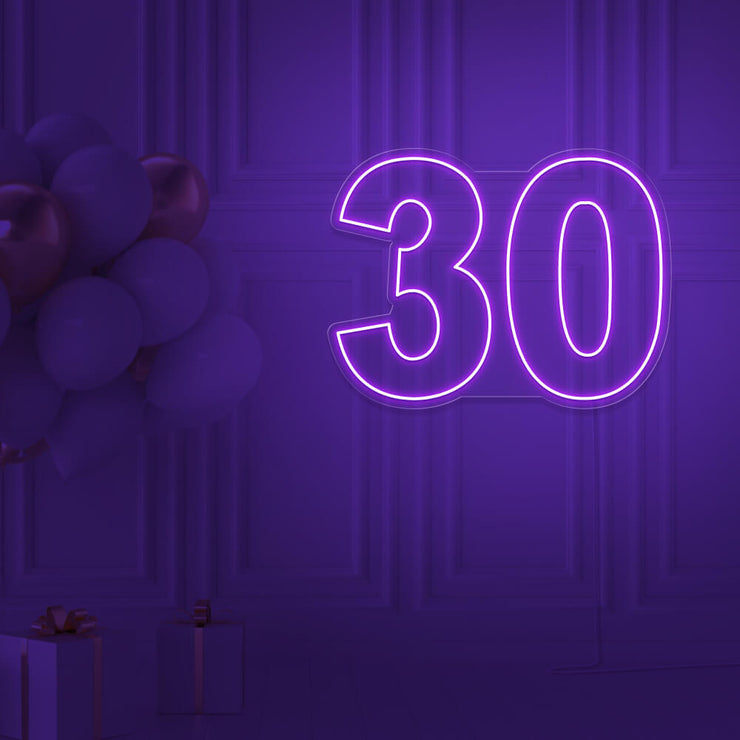purple 30 neon sign hanging on wall with balloons