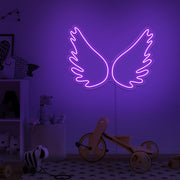 purple angel wings neon sign hanging on kids bedroom wall