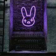 purple bad bunny neon sign hanging on bar wall