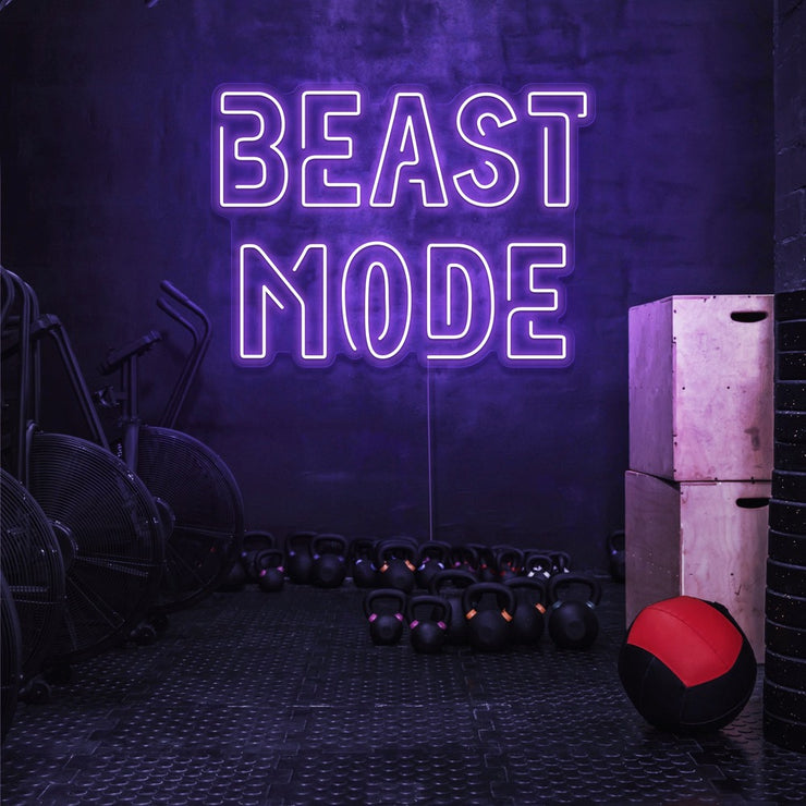 purple beast mode neon sign hanging on gym wall
