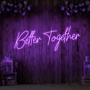 purple better together neon sign hanging on timber wall