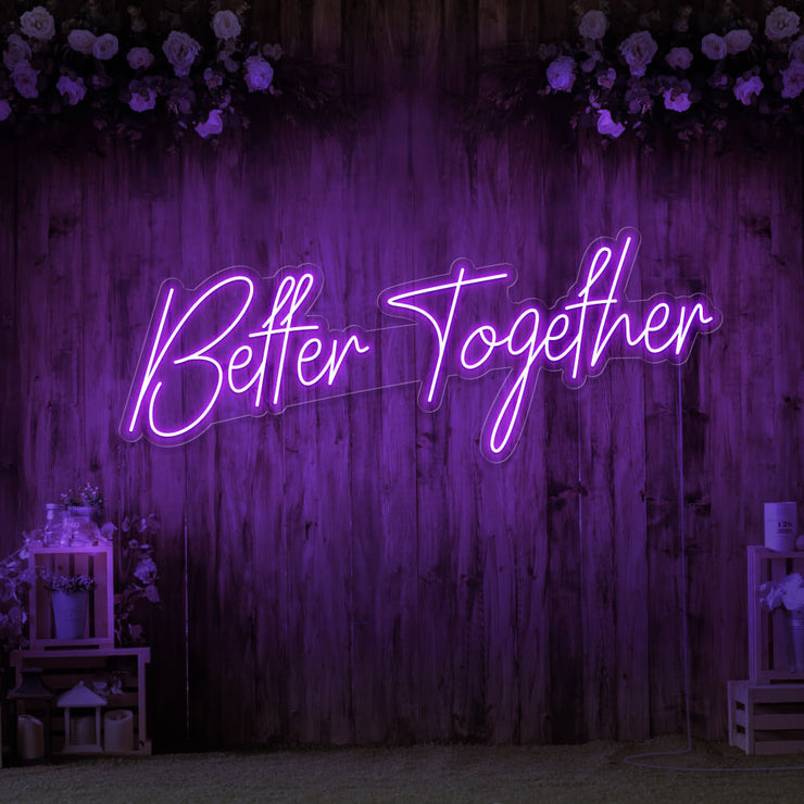 purple better together neon sign hanging on timber wall