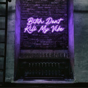 purple bitch don't kill my vibe neon sign hanging on bar wall