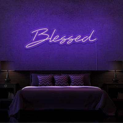 purple blessed neon sign hanging on bedroom wall
