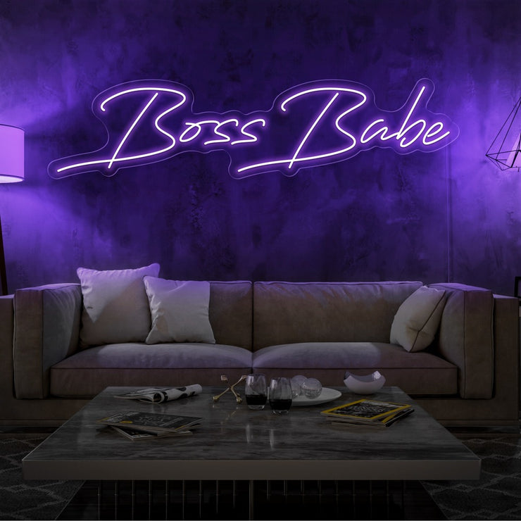 purple boss babe neon sign hanging on living room wall