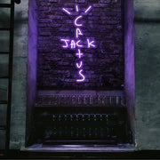 purple cactus jack neon sign hanging on bar wall