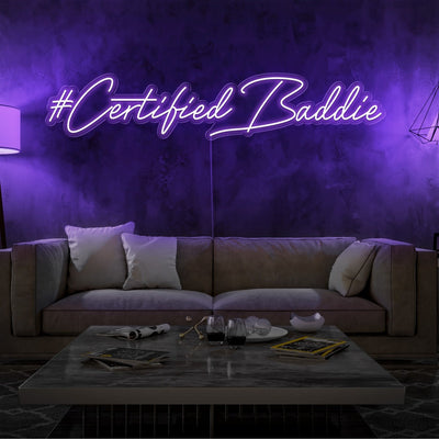 purple certified baddie neon sign hanging on living room wall