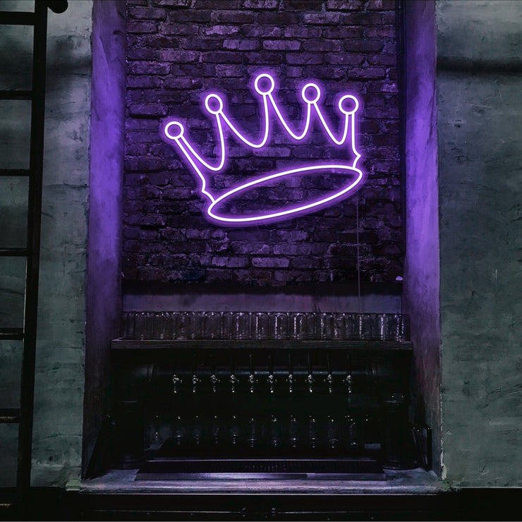 purple crown neon sign hanging on bar wall