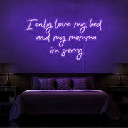 purple i only love my bed and my momma im sorry neon sign hanging on bedroom wall