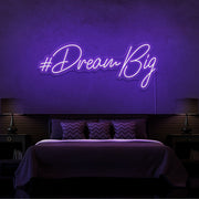 purple dream big neon sign hanging on bedroom wall