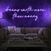 purple dreams worth more than money neon sign hanging on living  room wall