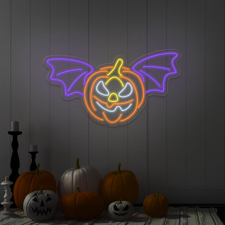 purple flying pumpkin neon sign hanging on wall above pumpkins
