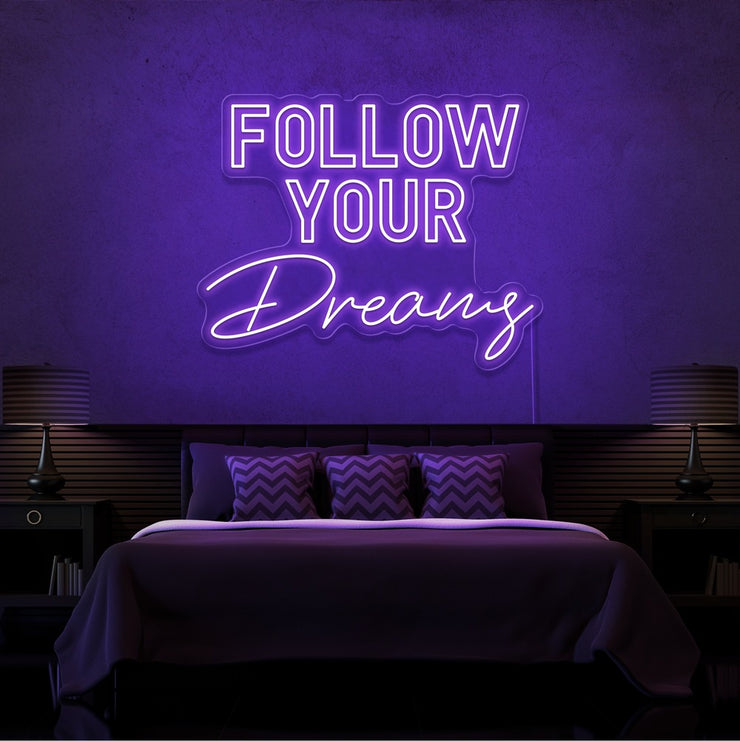 purple follow your dreams neon sign hanging on bedroom wall