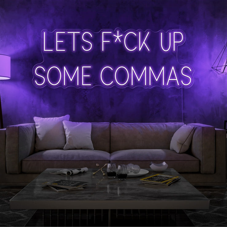 purple lets fuck up commas neon sign hanging on living room wall