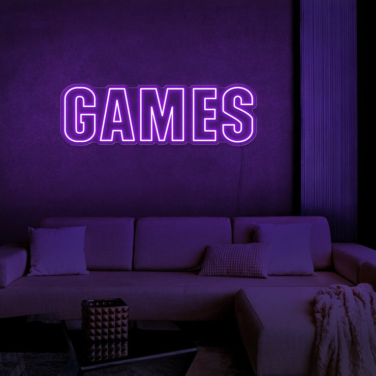 purple games neon sign hanging on games room wall