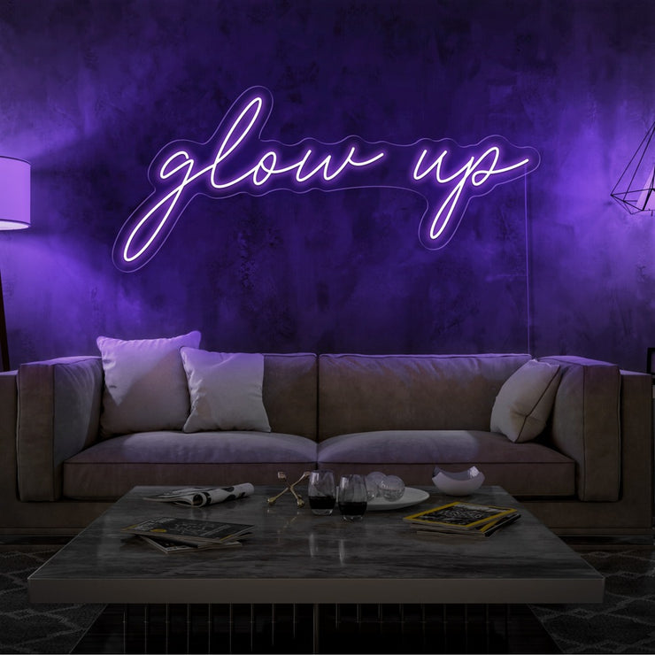 purple glow up neon sign hanging on living room wall