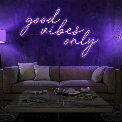 purple good vibes only neon sign hanging on living room wall
