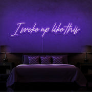purple i woke up like this neon sign hanging on bedroom wall