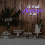 purple it was always you neon sign hanging above dessert table