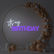 purple it's my birthday neon sign hanging in gold hoop backdrop with balloons