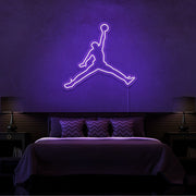purple jordan jumpman neon sign hanging on bedroom wall