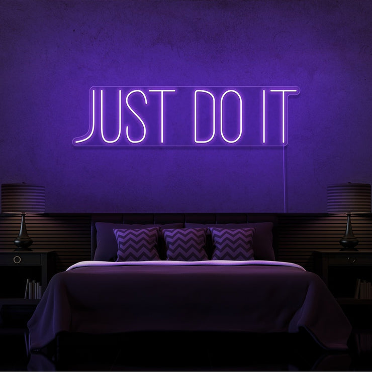 purple just do it neon sign hanging on bedroom wall