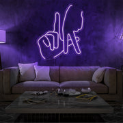 purple LA fingers neon sign hanging on living room wall