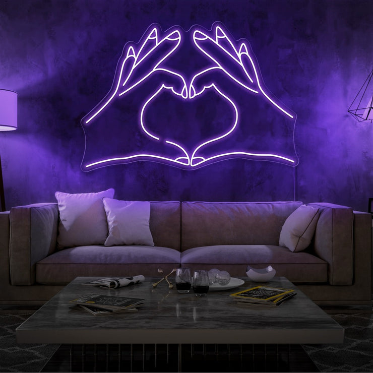 purple love hands neon sign hanging on living room wall