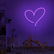 purple love heart neon sign hanging on kids bedroom wall