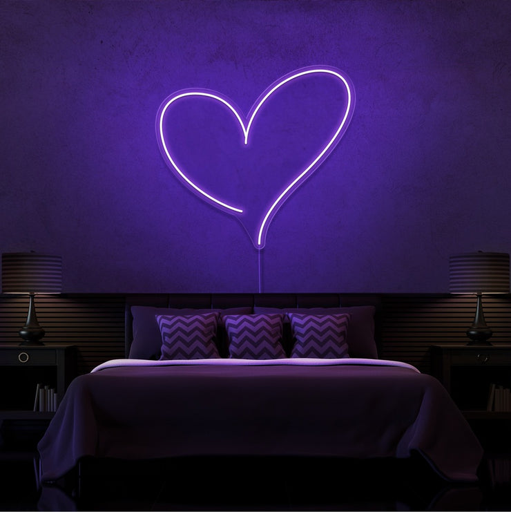 purple love heart neon sign hanging on bedroom wall
