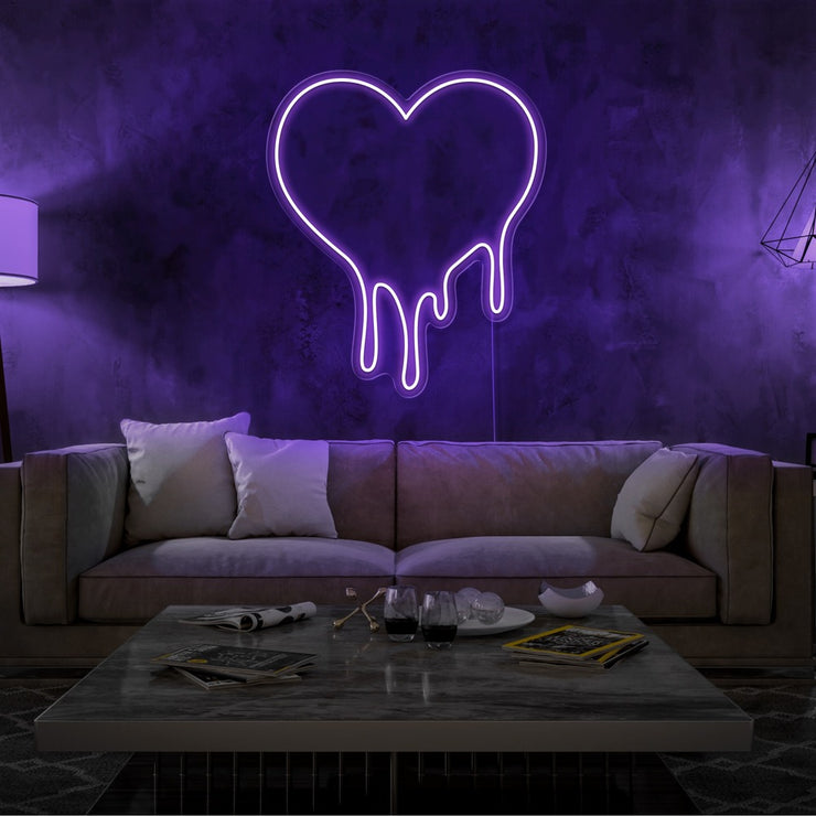 purple melting heart neon sign hanging on living room wall