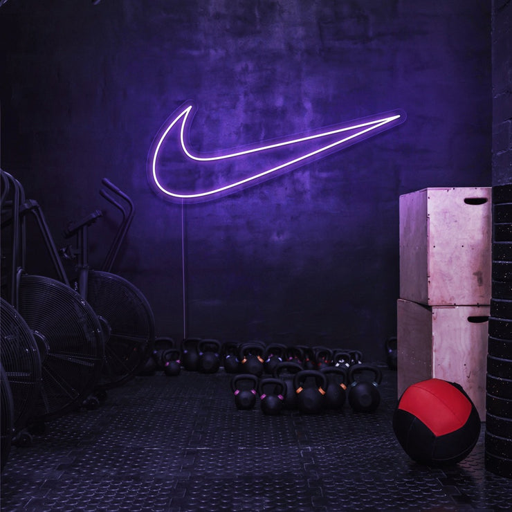 purple nike swoosh neon sign hanging on gym wall