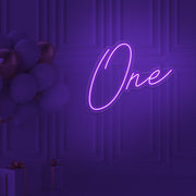 purple 1st birthday neon sign hanging on wall with balloons