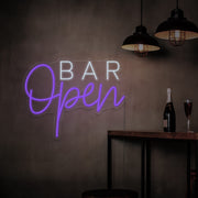 purple open bar neon sign hanging on bar wall
