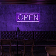 purple open neon sign hanging on cafe wall