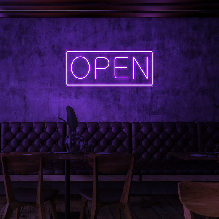 purple open neon sign hanging on cafe wall