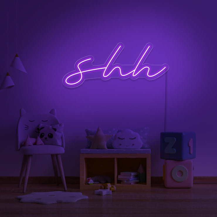purple shh neon sign hanging on kids bedroom wall